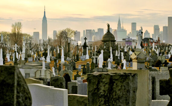 Headstones in Calvary Cemetery with NYC Skyline in Background